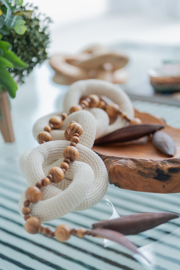 Stylish knitted and wooden decor elements on a rustic table create a cozy atmosphere.